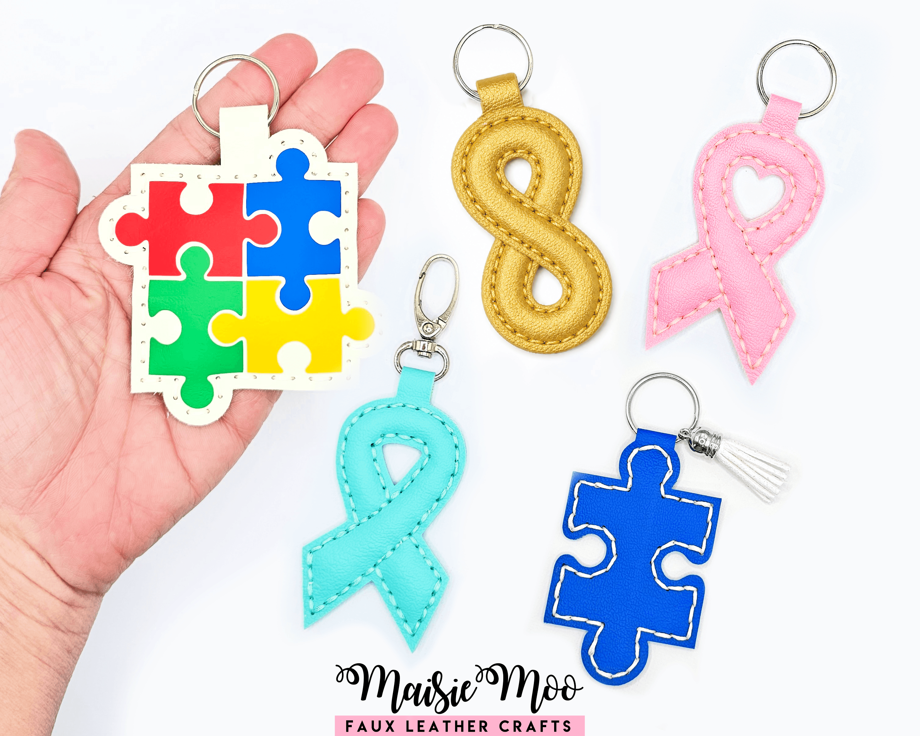 Colorful awareness ribbon keychain collection featuring puzzle piece, 8, and ribbon designs.