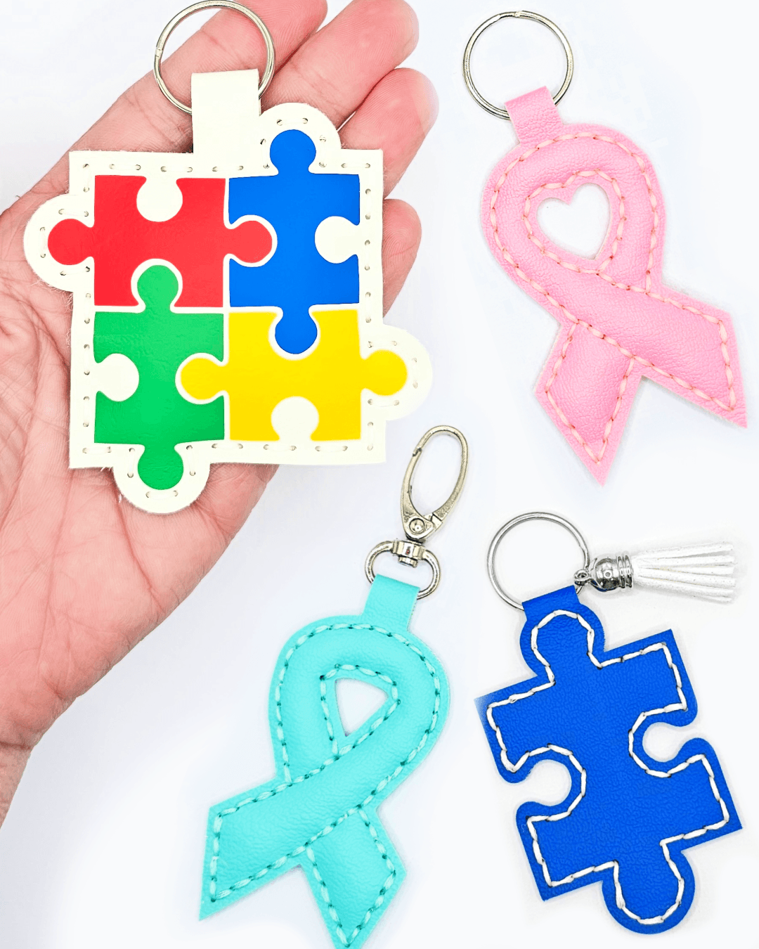 Awareness ribbon keychain collection featuring colorful puzzle pieces and ribbon designs, ideal for spreading awareness.