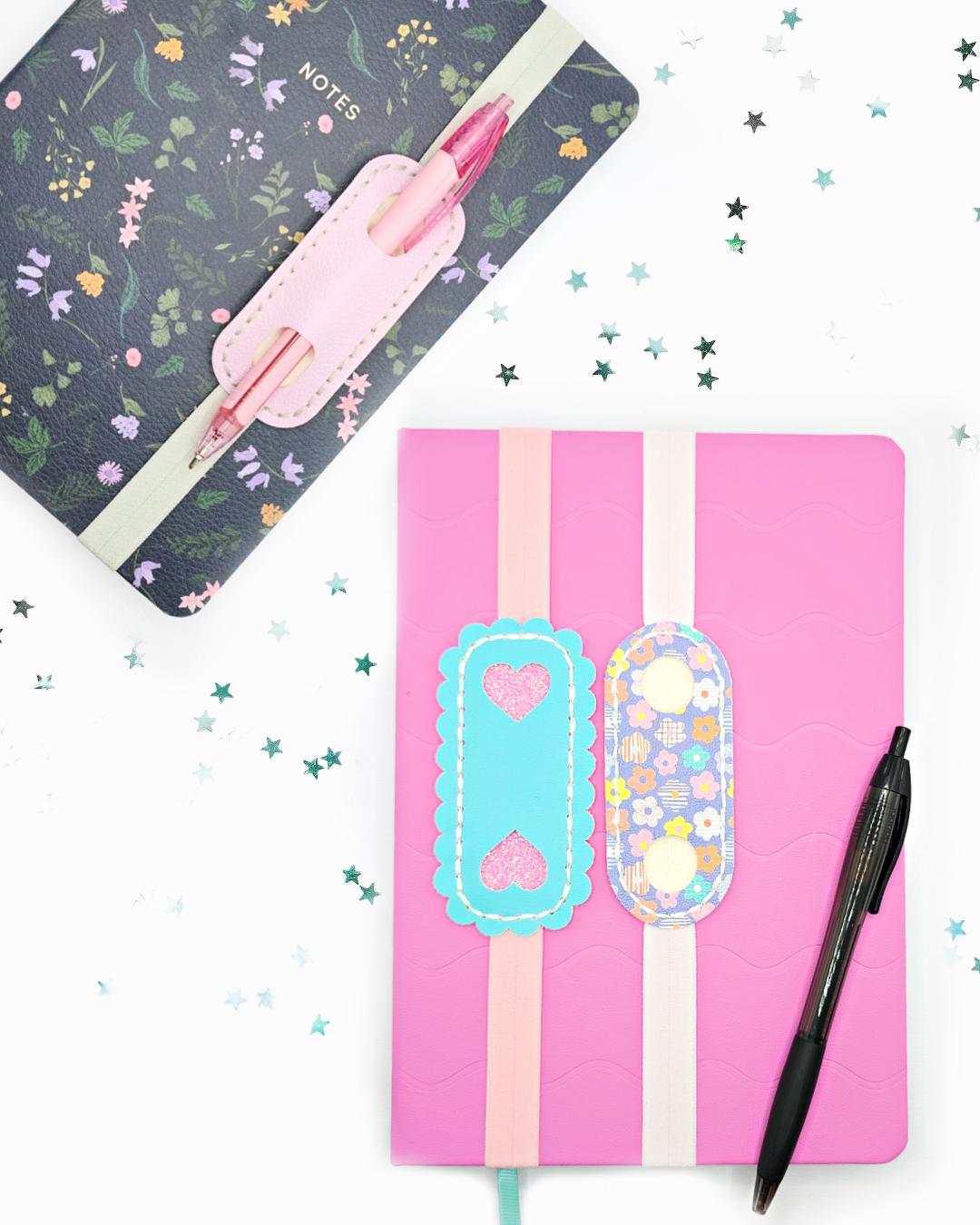 Elastic Pen Holder Bookmark attached to colorful notebooks with pens on a white background.