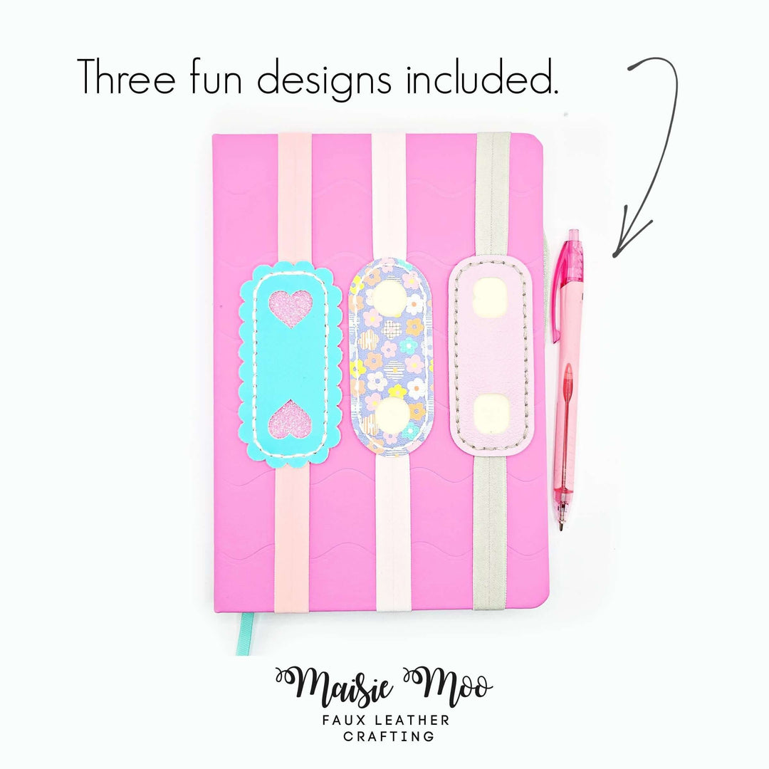 Elastic Pen Holder Bookmark on a pink notebook with three fun designs and a pen.