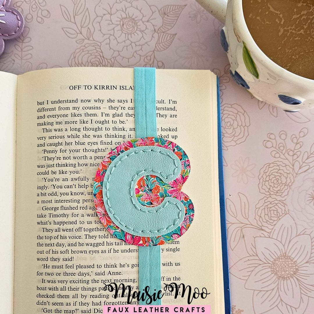 Alphabet Bookmark SVG Set for Cricut featuring a floral initial C on a blue faux leather bookmark.