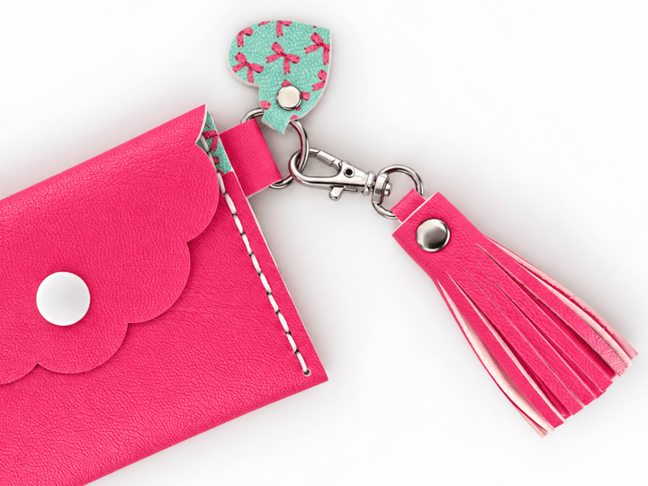 FREE Faux Leather Rivet Tassel Pattern – 4 Sizes, pink tassel attached to a coin purse with scalloped design.